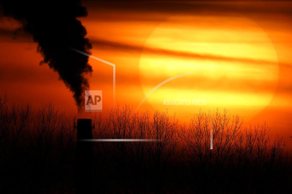 Charlie Riedel FILE - In this Feb. 1, 2021 file photo, emissions from a coal-fired power plant are silhouetted against the setting sun in Independence, Mo. President Joe Biden faces a vexing task as he convenes a virtual climate summit on Thursday. He is expected to present a nonbinding but symbolic goal to reduce greenhouse gas emissions that will have a tangible impact not only on climate change efforts in the U.S. but throughout the world. (AP Photo/Charlie Riedel, File)