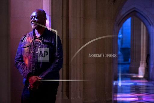 Artist Kerry James Marshall poses for a portrait in the National Cathedral after being selected to design a replacement of former confederate-themed stained glass windows that were taken down in 2017, in Washington, Thursday, Sept. 23, 2021. (AP Photo/Andrew Harnik)