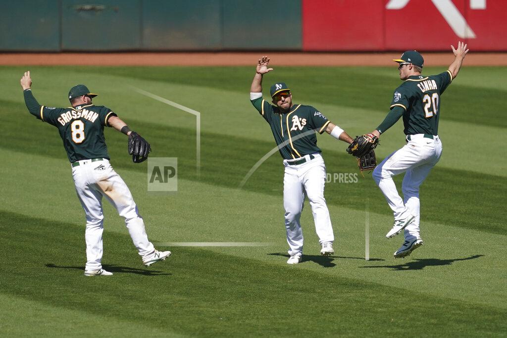 Jeff Chiu Oakland Athletics' Robbie Grossman, left, celebrates with Ramon Laureano and Mark Canha, right, after the Athletics defeated the Los Angeles Angels 6-4 in a baseball game in Oakland, Calif., Sunday, July 26, 2020. (AP Photo/Jeff Chiu)