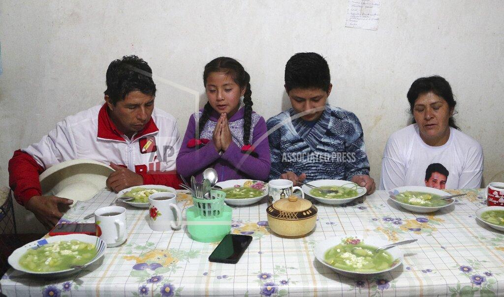 Martin Mejia Free Peru party presidential candidate Pedro Castillo, from left, daughter Alondra, son Arnold and wife Lilia Paredes, pray before eating breakfast, in their home in Chugur, Peru, Friday, April 16, 2021. Castillo, a rural teacher, who has proposed rewriting Peru's constitution and deporting all immigrants living in the country illegally who commit crimes, will face rival candidate Keiko Fujimori in the June 6 presidential run-off election. (AP Photo/Martin Mejia)