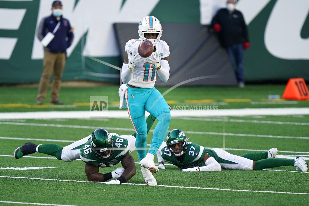 Corey Sipkin Miami Dolphins' DeVante Parker makes a catch in front of New York Jets defenders during the first half of an NFL football game, Sunday, Nov. 29, 2020, in East Rutherford, N.J. (AP Photo/Corey Sipkin)
