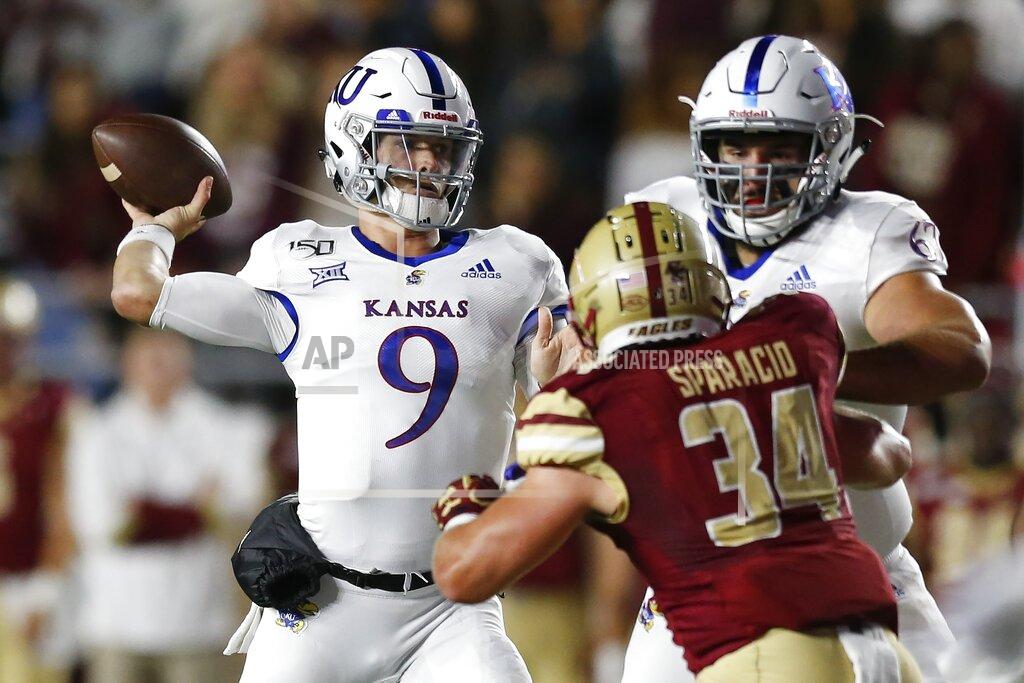 Michael Dwyer Kansas quarterback Carter Stanley (9) passes under pressure from Boston College linebacker Joseph Sparacio (34) during the first half of an NCAA college football game in Boston, Friday, Sept. 13, 2019. (AP Photo/Michael Dwyer)