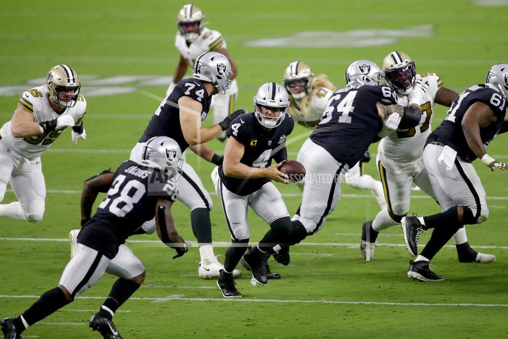 Isaac Brekken Las Vegas Raiders quarterback Derek Carr (4) prepares to hand the ball off to running back Josh Jacobs (28) during the first half of an NFL football game, Monday, Sept. 21, 2020, in Las Vegas. (AP Photo/Isaac Brekken)