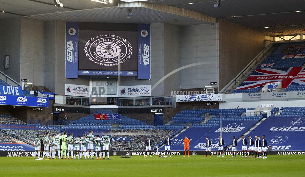 Andrew Milligan Both teams observe a minute of silence on the 50th anniversary of the Ibrox disaster ahead of the Scottish Premiership match between Rangers and Celtic at Ibrox Stadium, Glasgow, Saturday Jan. 2, 2021. The anniversary marks 50 years since the disaster at the stadium which claimed the lives of 66 people. The fans were crushed on a stairway when barriers collapsed at the Glasgow venue. (Andrew Milligan/PA via AP)