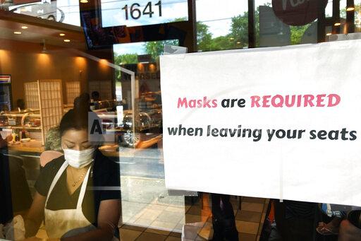 FILE - In this June 17, 2021, file photo, a sign requiring masks is displayed at a restaurant in Rolling Meadows, Ill. (AP Photo/Nam Y. Huh, File)