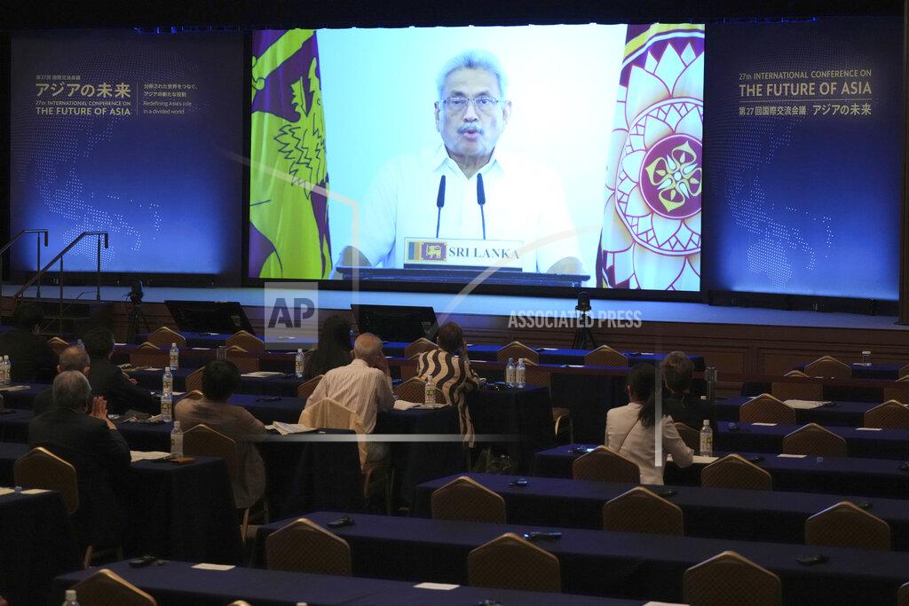 Eugene Hoshiko Participants look at Sri Lankan President Gotabaya Rajapaksa's pre-recorded speech shown on a screen at a session of the International Conference on "The Future of Asia" Thursday, May 26, 2022 in Tokyo. (AP Photo/Eugene Hoshiko)