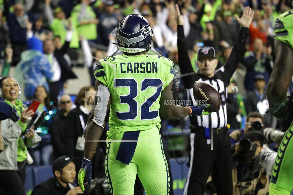 Elaine Thompson Seattle Seahawks running back Chris Carson holds the ball after scoring a touchdown against the Los Angeles Rams during the second half of an NFL football game Thursday, Oct. 3, 2019, in Seattle. (AP Photo/Elaine Thompson)