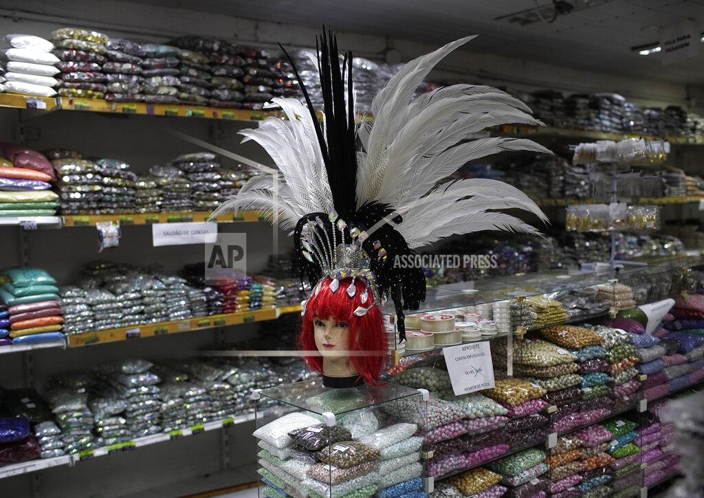 Silvia Izquierdo A mannequin head dons a Carnival feather headdress for sale at a costume party store in Rio de Janeiro, Brazil, Thursday, Feb. 4, 2021, amid the COVID-19 pandemic. The cancellation of Carnival celebrations due to the new coronavirus pandemic has created a deep economic hole for many businesses dependent on the massive crowds attracted to the annual street party. (AP Photo/Silvia Izquierdo)