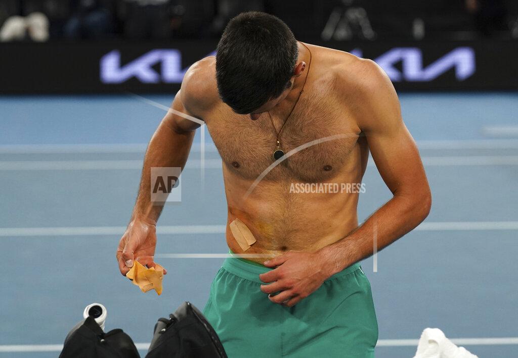 Mark Dadswell Serbia's Novak Djokovic takes a bandage off after defeating Russia's Daniil Medvedev in the men's singles final at the Australian Open tennis championship in Melbourne, Australia, Sunday, Feb. 21, 2021.(AP Photo/Mark Dadswell)