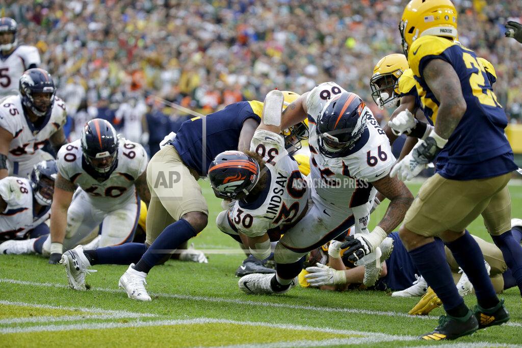 Mike Roemer Denver Broncos running back Phillip Lindsay (30) scores during the second half of an NFL football game against the Green Bay Packers, Sunday, Sept. 22, 2019, in Green Bay, Wis. (AP Photo/Mike Roemer)