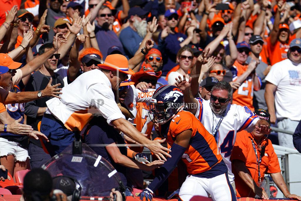 Jack Dempsey Denver Broncos wide receiver Courtland Sutton, below right, reacts with fans after scoring a touchdown during the first half of an NFL football game against the Jacksonville Jaguars, Sunday, Sept. 29, 2019, in Denver. (AP Photo/Jack Dempsey)