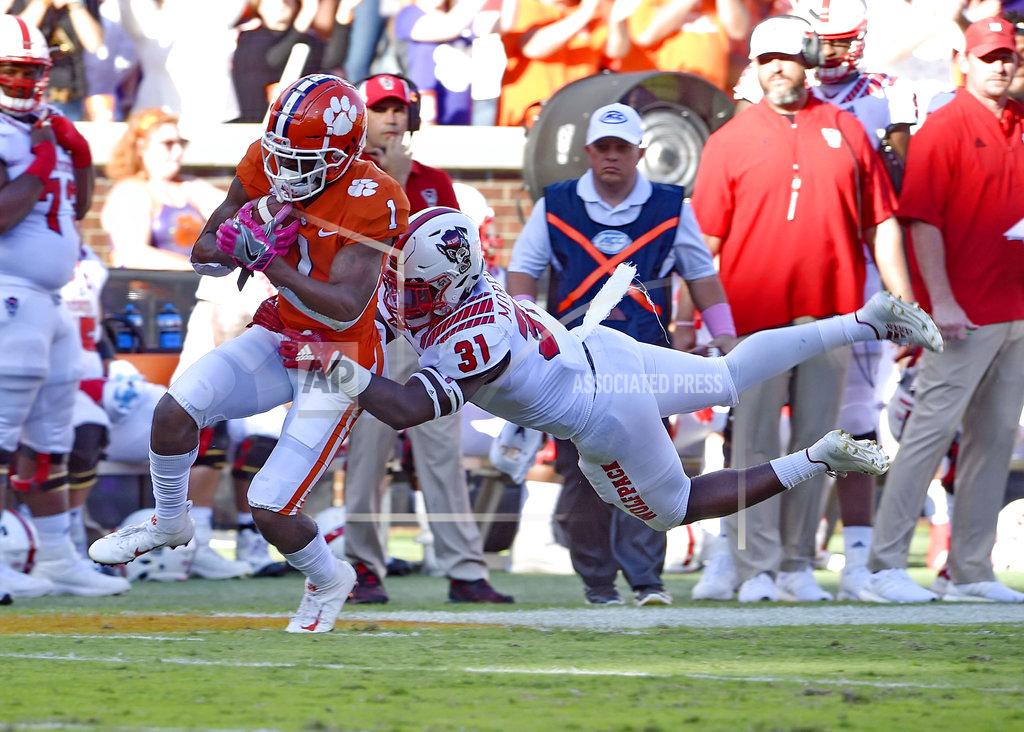 Richard Shiro Clemson's Trevion Thompson rushes after a catch while defended by North Carolina State's Jarius Morehead during the first half of an NCAA college football game Saturday, Oct. 20, 2018, in Clemson, S.C. (AP Photo/Richard Shiro)