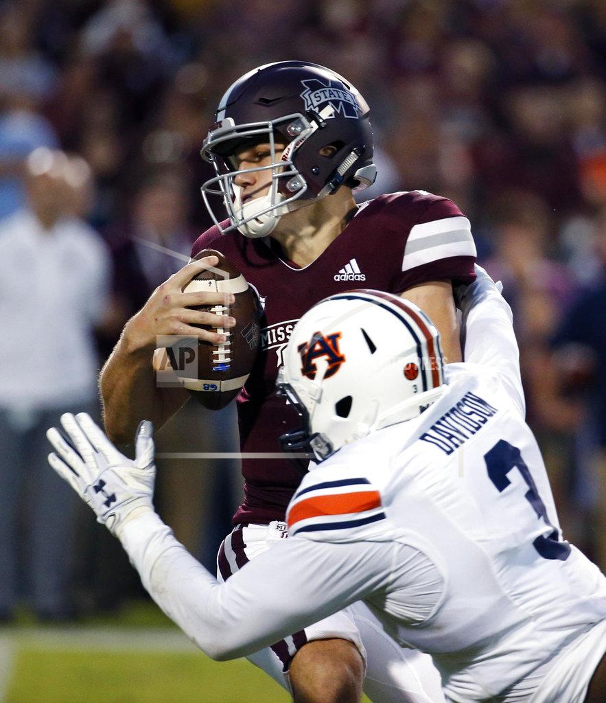 Rogelio V. Solis Mississippi State quarterback Nick Fitzgerald (7) avoids a sack by Auburn defensive lineman Marlon Davidson (3) during the first half of their NCAA college football game in Starkville, Miss., Saturday, Oct. 6 2018. (AP Photo/Rogelio V. Solis)