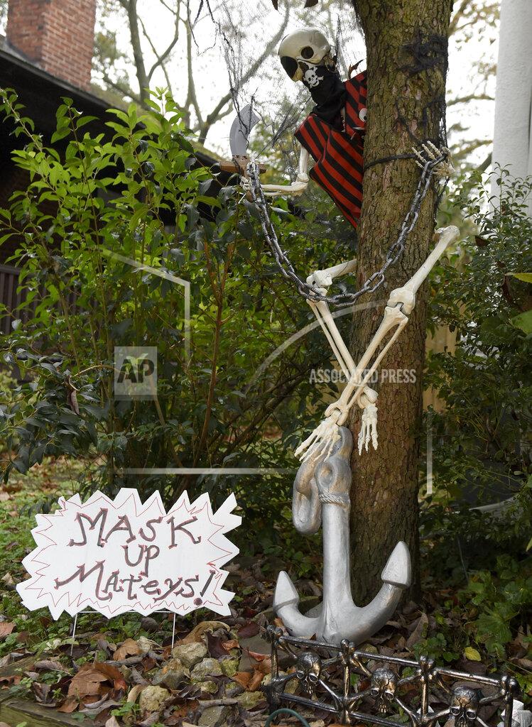 Michael Perez Pirate-themed Halloween decorations are seen at the home of Carol McCarthy, reminding people to be safe while trick-or-treating during the COVID-19 pandemic, Monday, Oct. 26, 2020, in Palmyra, N.J. (AP Photo/Michael Perez)