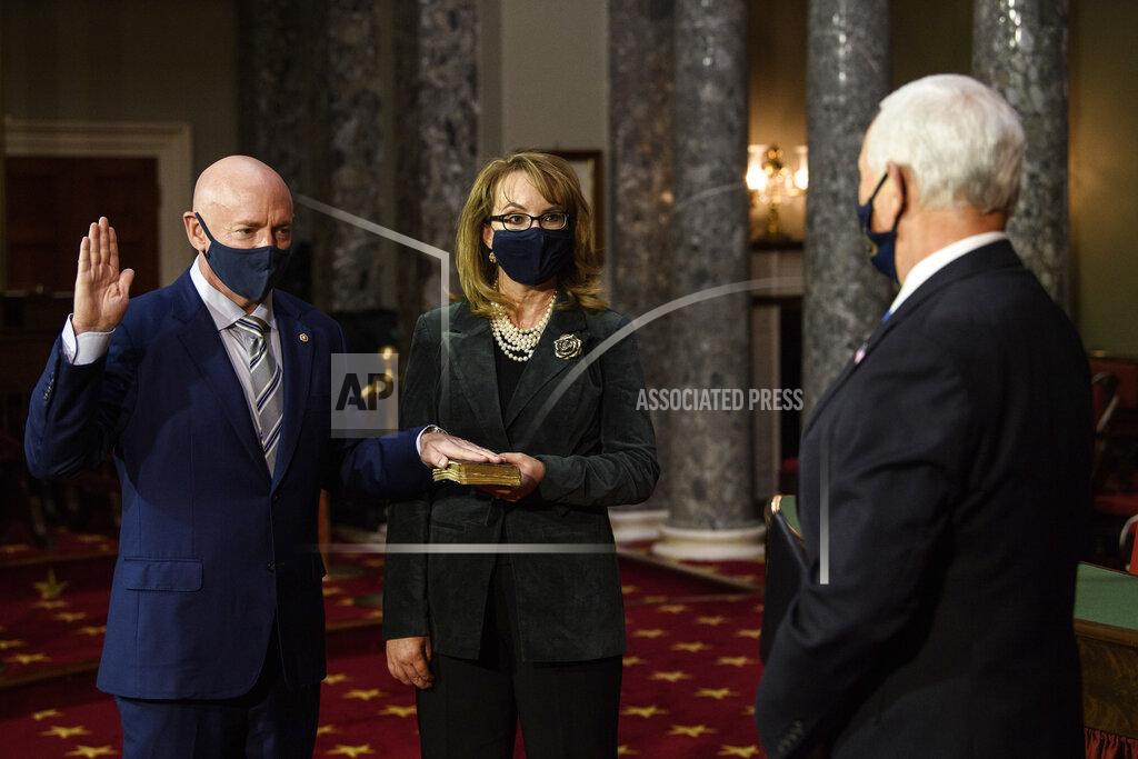 Nicholas Kamm Sen. Mark Kelly, D-Ariz., with his wife former Rep. Gabby Giffords, D-Ariz., participates in a re-enactment of his swearing-in Wednesday, Dec. 2, 2020, by Vice President Mike Pence in the Old Senate Chamber on Capitol Hill in Washington. (Nicholas Kamm/Pool via AP)