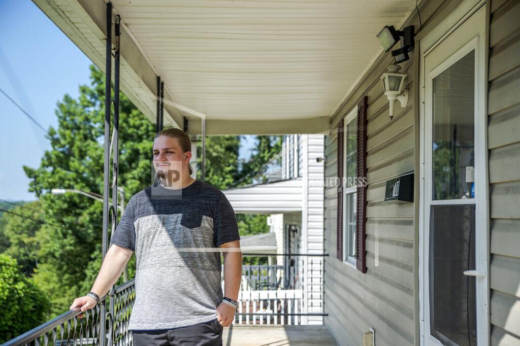 Kendall Warner Tiler McFadden poses for a portrait on the front porch of the home he recently purchased in Lynchburg, Va. on Friday, Aug. 27, 2021. (Kendall Warner/The News & Advance via AP)