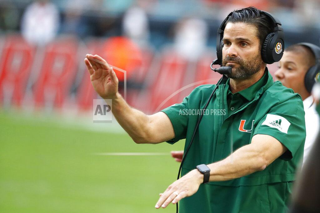 FILE - In this Saturday, Nov. 9, 2019, file photo, Miami head coach Manny Diaz calls out a play during the first half of an NCAA college football game against Louisville in Miami Gardens, Fla. The Hurricanes’ head coach — and former defensive coordinator — will call the plays on that side of the football in 2021, he said Thursday, Jan. 14, 2021 while announcing a slew of other changes including the return of Jess Simpson to coach defensive line(AP Photo/Wilfredo Lee, File)
