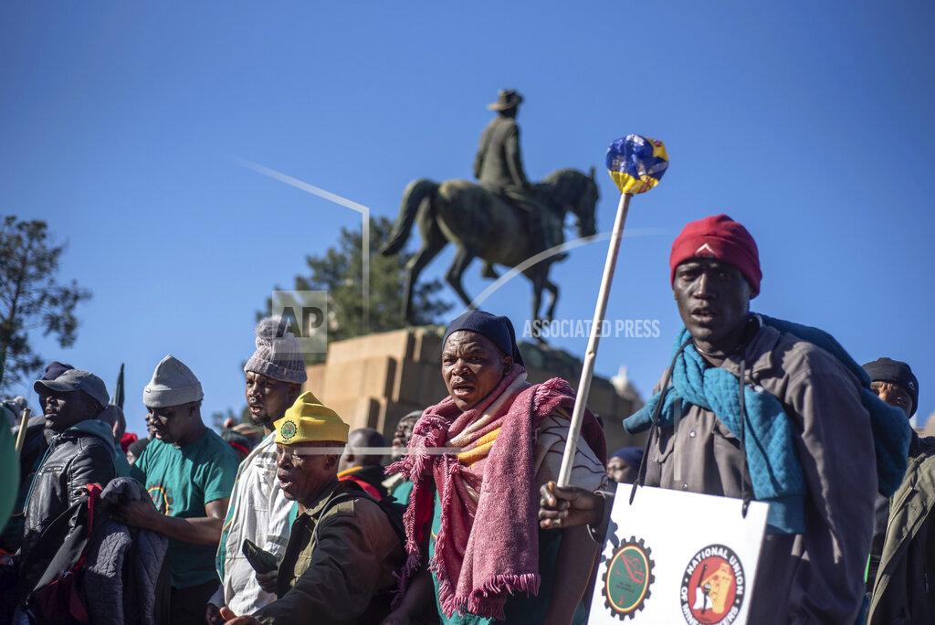 Uncredited Striking miners protest for higher wages at the Union Buildings, in Pretoria, South Africa, Tuesday, May 24, 2022 as German Chancellor Olaf Scholz meets with South African President Cyril Ramaphosa on a one-day visit to the country. (AP Photo)