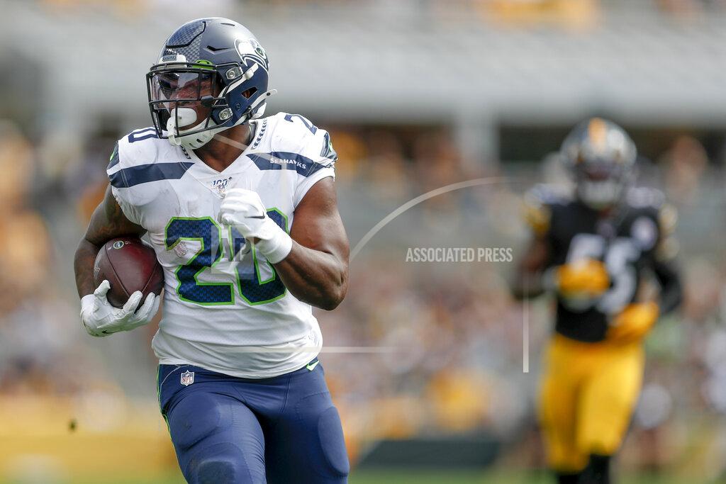 Don Wright Seattle Seahawks running back Rashaad Penny (20) carries the ball away from Pittsburgh Steelers linebacker Devin Bush (55) on his way to a long touchdown run in the second half of an NFL football game Sunday, Sept. 15, 2019, in Pittsburgh. (AP Photo/Don Wright)