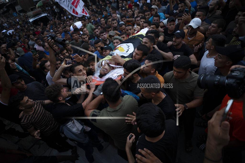 Fatima Shbair Palestinian mourners carry the bodies of victims killed earlier in an Israeli airstrike, during their funeral in Gaza City, Friday, Aug. 5, 2022. Palestinian officials say Israeli airstrikes on Gaza have killed several people, including a senior militant, and wounded 40 others. (AP Photo/Fatima Shbair)