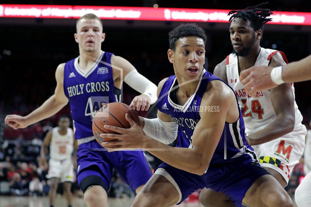 Julio Cortez Holy Cross forward Marlon Hargis, center, holds the ball after collecting a defensive rebound against Maryland during the first half of an NCAA college basketball game, Tuesday, Nov. 5, 2019, in College Park, Md. (AP Photo/Julio Cortez)