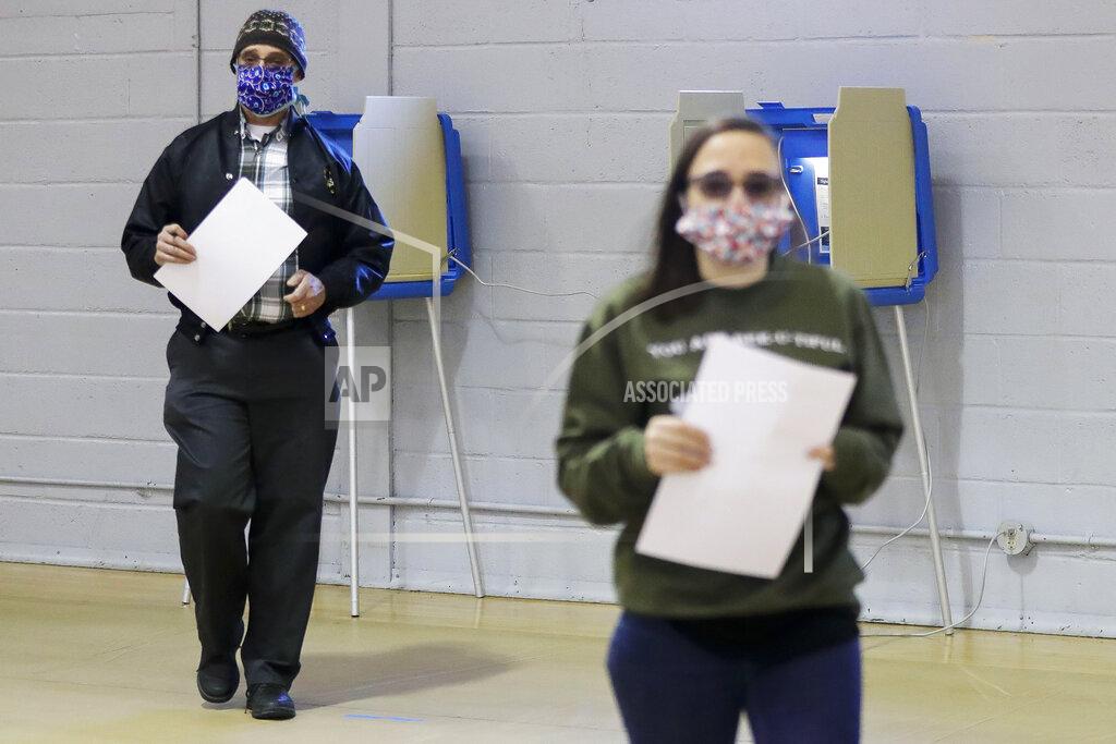 Tork Mason Peter Smith heads to the voting machine after filling out his ballot for the Wisconsin 7th District special election on Tuesday, May 12, 2020, at the Oak Avenue Community Center in Marshfield, Wis. Republican Tom Tiffany and Democrat Tricia Zunker are vying to fill the vacancy left by Republican Sean Duffy, who resigned from the seat in September. (Tork Mason/The Post-Crescent via AP)
