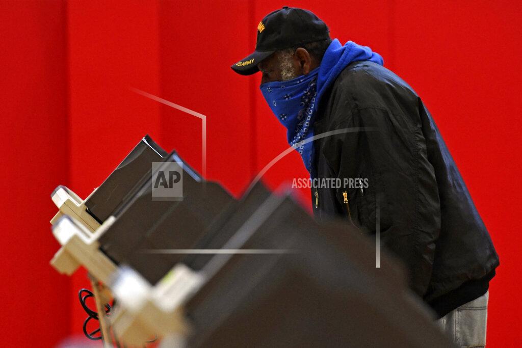 David Dermer Robert Powell casts his ballot at Alliance High School, Tuesday, Nov. 3, 2020, in Alliance, Ohio. (AP Photo/David Dermer)