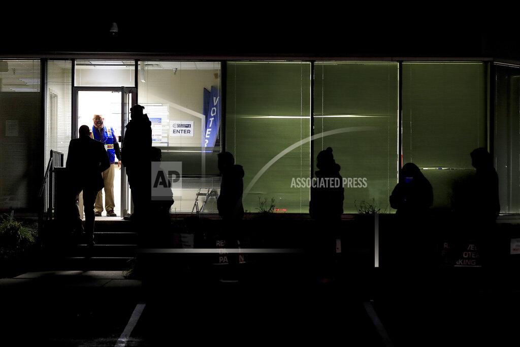 Aaron Doster People stand in line at the Hamilton County Board of Elections as they wait to vote, Tuesday, Nov. 3, 2020, in Norwood, Ohio. (AP Photo/Aaron Doster)