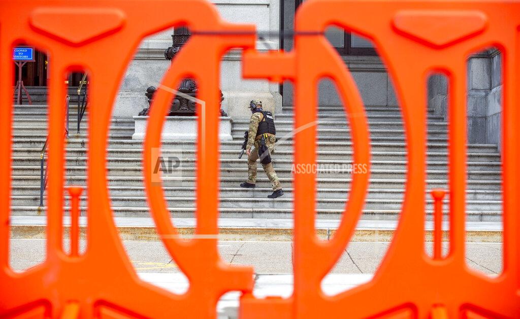 Mark Pynes A Capitol Police officer passes by fencing set up outside the Pennsylvania State Capitol in Harrisburg, Pa., Thursday, Jan. 14, 2021, in advance of Joe Biden's Presidential Inaugural in Washington D.C. on Jan. 20. (Mark Pynes/The Patriot-News via AP)
