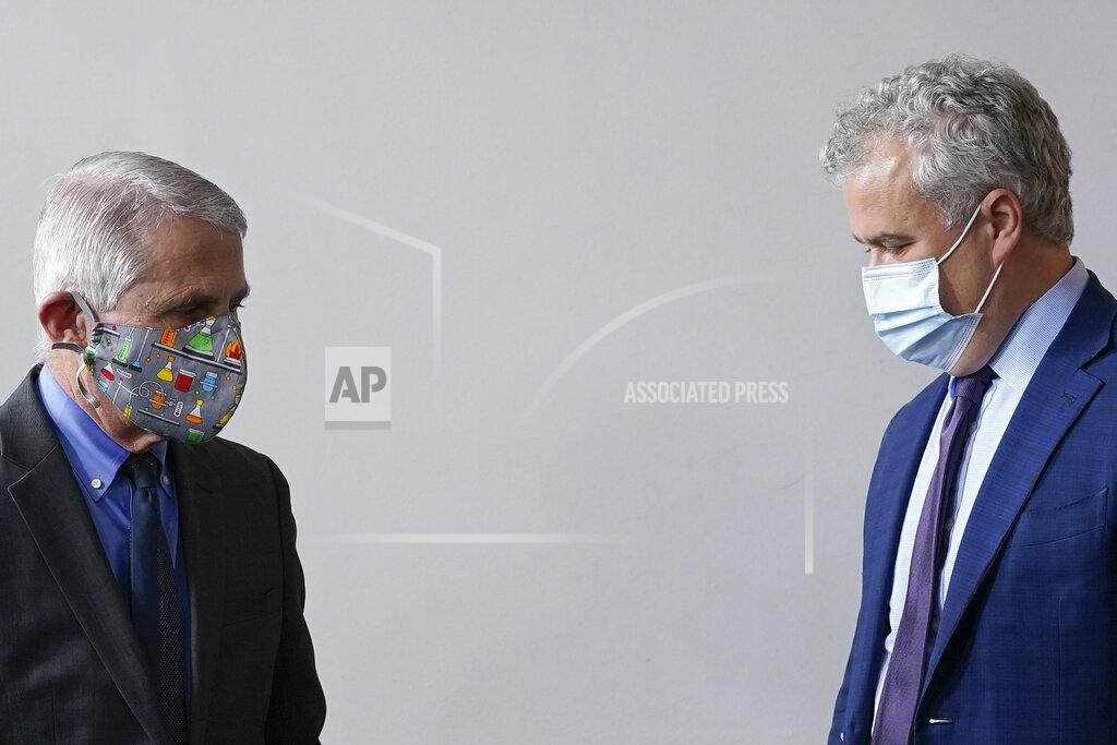 Dr. Anthony Fauci, left, director of the National Institute of Allergy and Infectious Diseases, and White House COVID-19 Response Coordinator Jeff Zients arrive for a press briefing at the White House, Tuesday, April 13, 2021, in Washington. (AP Photo/Patrick Semansky)