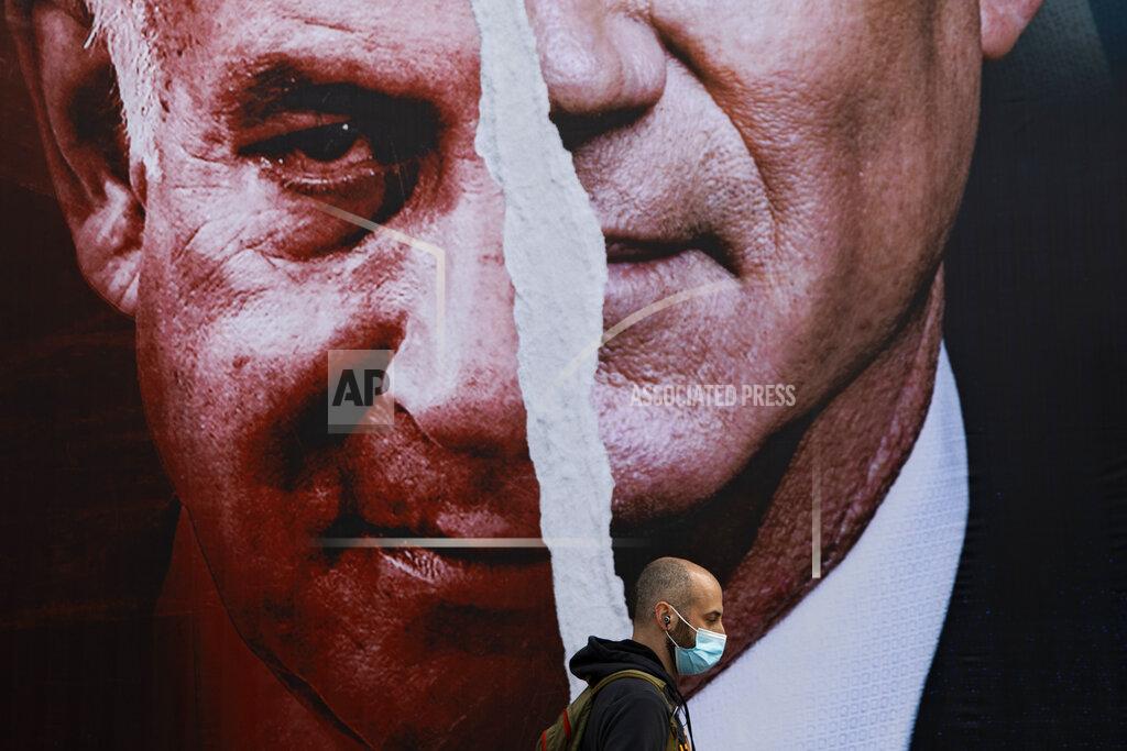 Oded Balilty FILE - In this March. 11, 2021 file photo, an election campaign billboard for the Blue and White party, the opposition party led by Benny Gantz, right, and Prime Minister Benjamin Netanyahu of the Likud party, left, hangs on a street in Tel Aviv, Israel. Israel is holding its fourth election in two years after two deadlocked votes and a government that collapsed after less than a year. It is widely seen as a one-issue referendum — with the electorate almost evenly divided — on whether longtime Prime Minister Benjamin Netanyahu can remain in power. (AP Photo/Oded Balilty, File)