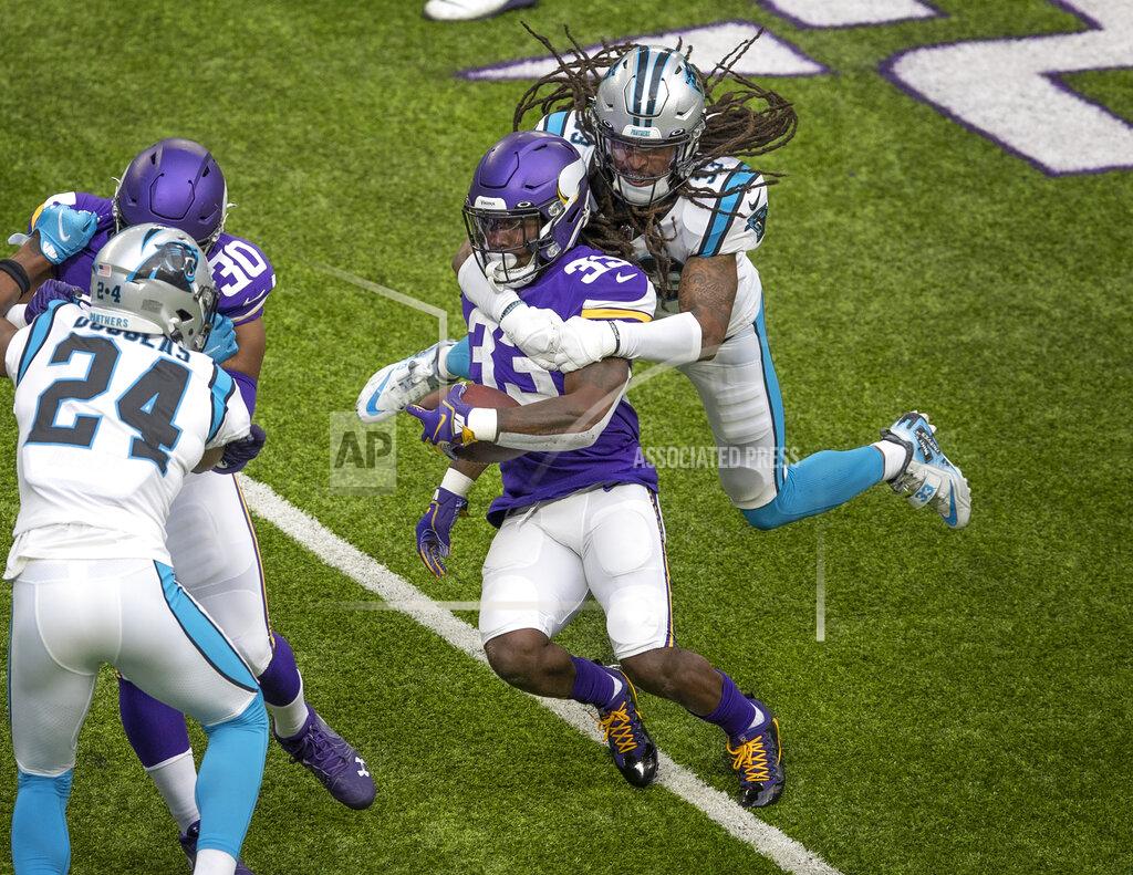Jerry Holt Carolina Panthers free safety Tre Boston (33) tackles Minnesota Vikings running back Dalvin Cook (33) in the first quarter of an NFL football game in Minneapolis, Sunday, Nov. 29, 2020. (Jerry HoltStar Tribune via AP)