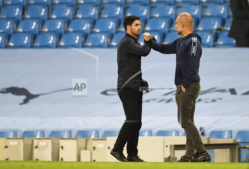 Peter Powell Arsenal's head coach Mikel Arteta, left, greets Manchester City's head coach Pep Guardiola after the English Premier League soccer match between Manchester City and Arsenal at the Etihad Stadium in Manchester, England, Wednesday, June 17, 2020. Manchester City won the match 3-0. The English Premier League resumes Wednesday after its three-month suspension because of the coronavirus outbreak. (Peter Powell/Pool via AP)