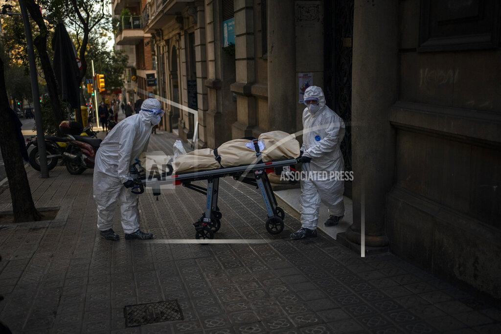 Emilio Morenatti Mortuary workers carry the body of an elderly person who died of COVID-19 after removing it from a nursing home in Barcelona, Spain, Friday, Nov. 13, 2020. Virus cases among the elderly are again on the rise across Europe, causing havoc and rising death tolls in nursing homes despite the lessons of a tragic spring. Authorities are in a race to save lives as they wait for crucial announcements on mass vaccinations. (AP Photo/Emilio Morenatti)