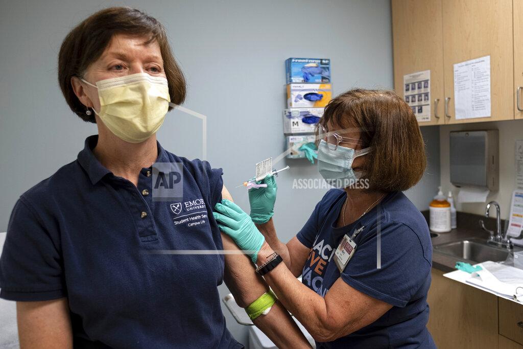 Ben Gray Carol Kelly, left, receives a Moderna variant vaccine shot from registered nurse Mary Bower at Emory University's Hope Clinic, Wednesday afternoon, March 31, 2021, in Decatur, Ga. Kelly was the first person to receive a shot in this new clinical trial. (AP Photo/Ben Gray)