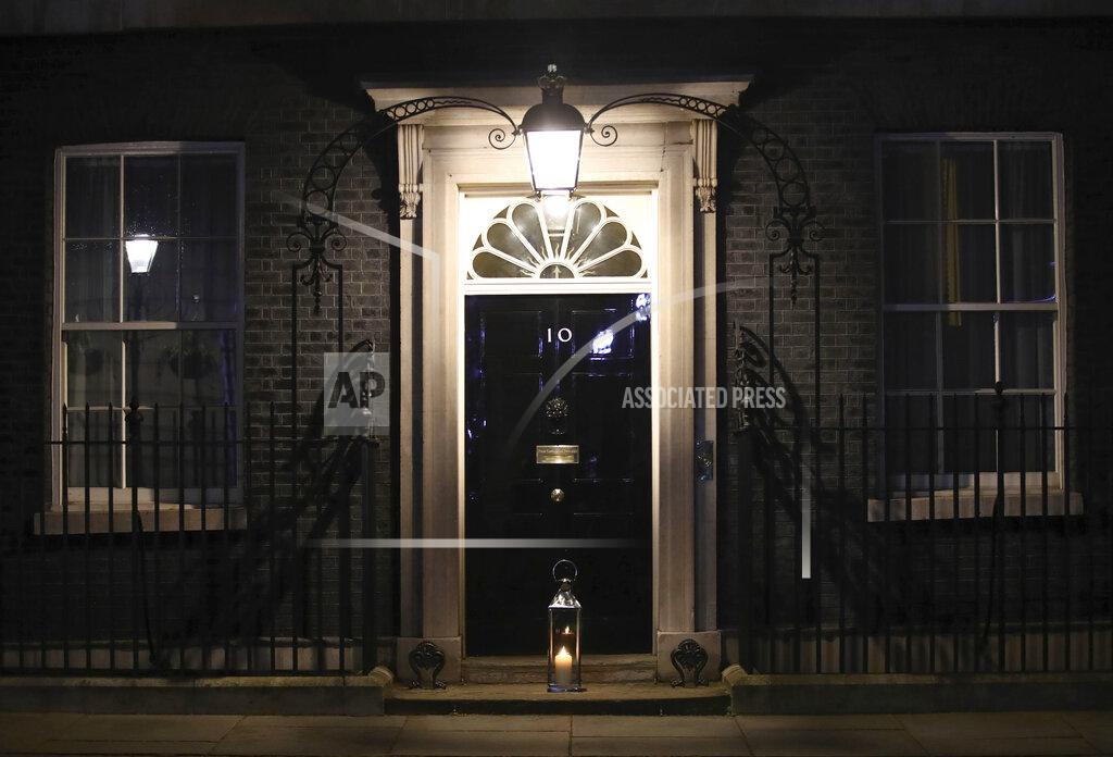 Aaron Chown A candle lit by Britain's Prime Minister Boris Johnson and his fiancee Carrie Symonds placed on the doorstep of 10 Downing Street, London, during a doorstep vigil for Sarah Everard, Saturday, March 13, 2021. A serving British police officer accused of the kidnap and murder of a woman in London has appeared in court for the first time. Wayne Couzens, 48, is charged with kidnapping and killing 33-year-old Sarah Everard, who went missing while walking home from a friend’s apartment in south London on March 3. (Aaron Chown/PA via AP)