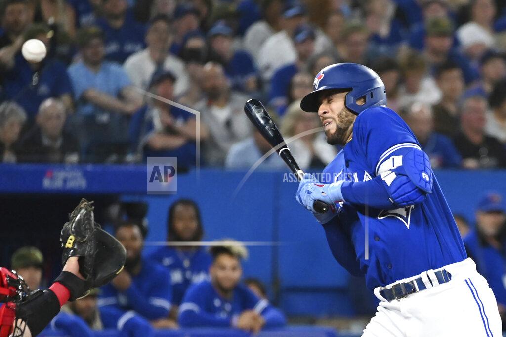 Jon Blacker Toronto Blue Jays' George Springer is hit by a pitch from Cincinnati Reds' Hunter Strickland during the seventh inning of a baseball game Friday, May 20, 2022, in Toronto. (Jon Blacker/The Canadian Press via AP)