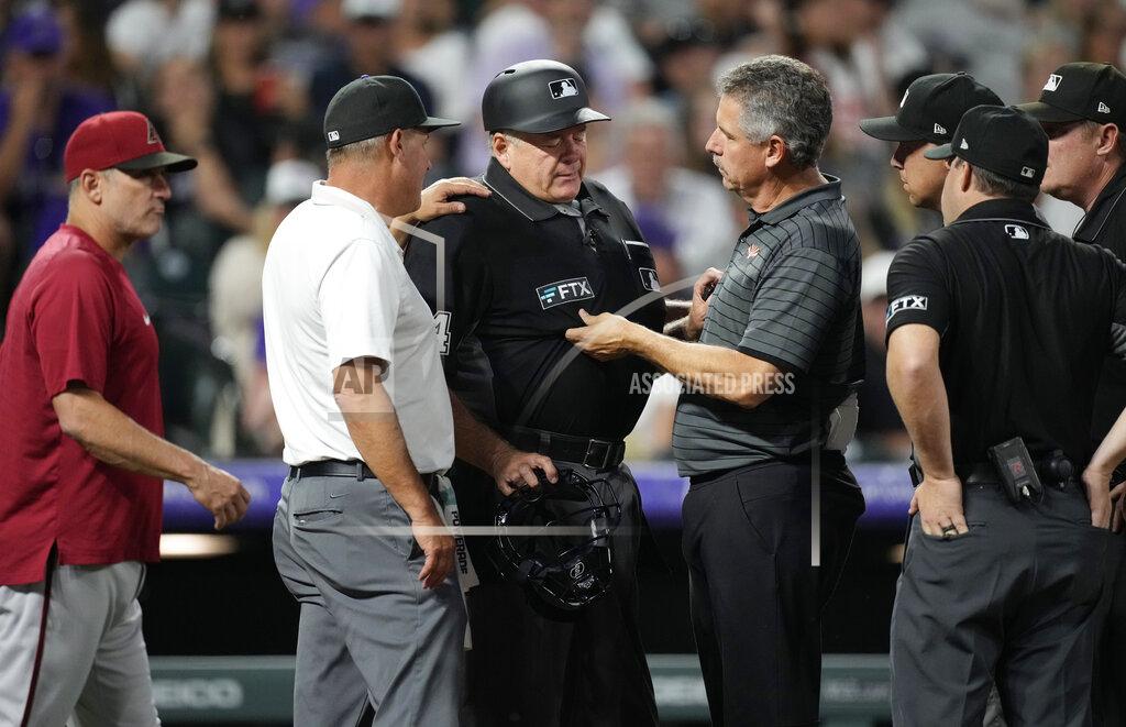 David Zalubowski Trainers check on home plate umpire Jerry Layne before he left his position during the sixth inning of a baseball game between the Arizona Diamondbacks and the Colorado Rockies on Saturday, July 2, 2022, in Denver. (AP Photo/David Zalubowski)