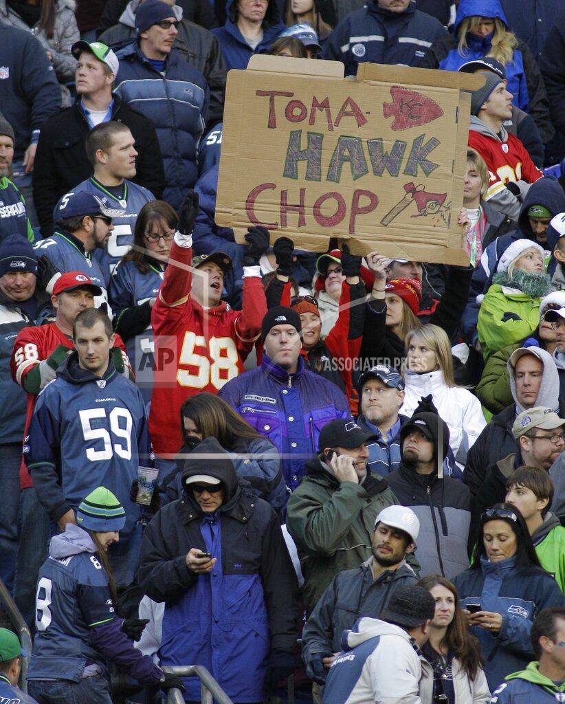 Ted S. Warren FILE - In this Nov. 28, 2010, file photo, Kansas City Chiefs fans hold a sign that reads "TomaHAWK Chop," during an NFL football game between the Chiefs and the Seattle Seahawks in Seattle. The Kansas City Chiefs barred headdresses and war paint amid the nationwide push for racial justice, but its effort to make its popular “war chant” more palatable is getting a fresh round of scrutiny from Native American groups as the team prepares to make its second straight Super Bowl appearance. (AP Photo/Ted S. Warren, File)