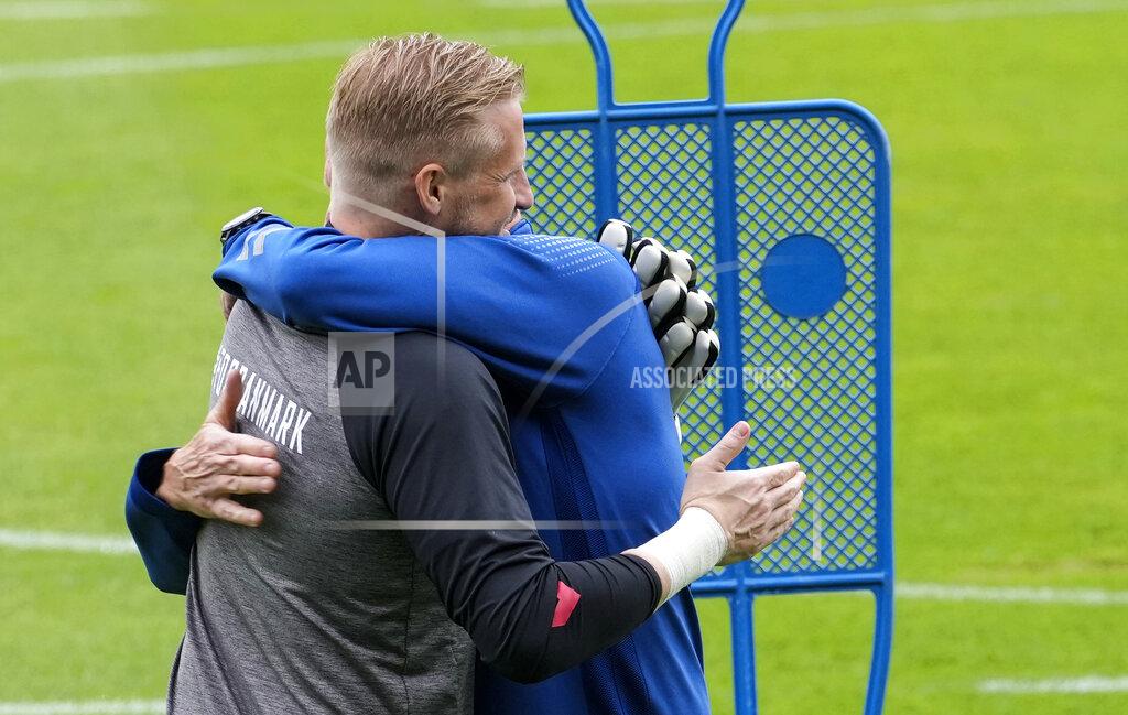 Martin Meissner Denmark's goalkeeper Kasper Schmeichel is embraced at the training ground during a training session of Denmark's national team in Helsingor, Denmark, Monday, June 14, 2021. It is the first training of the Danish team since the Euro championship soccer match against Finland when Christian Eriksen collapsed last Saturday. (AP Photo/Martin Meissner)
