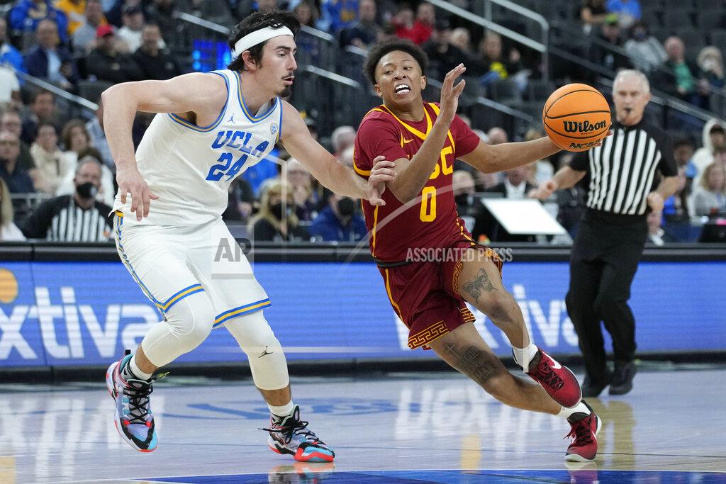 John Locher Southern California's Boogie Ellis (0) drives around UCLA's Jaime Jaquez Jr. (24) during the second half of an NCAA college basketball game in the semifinal round of the Pac-12 tournament Friday, March 11, 2022, in Las Vegas. (AP Photo/John Locher)