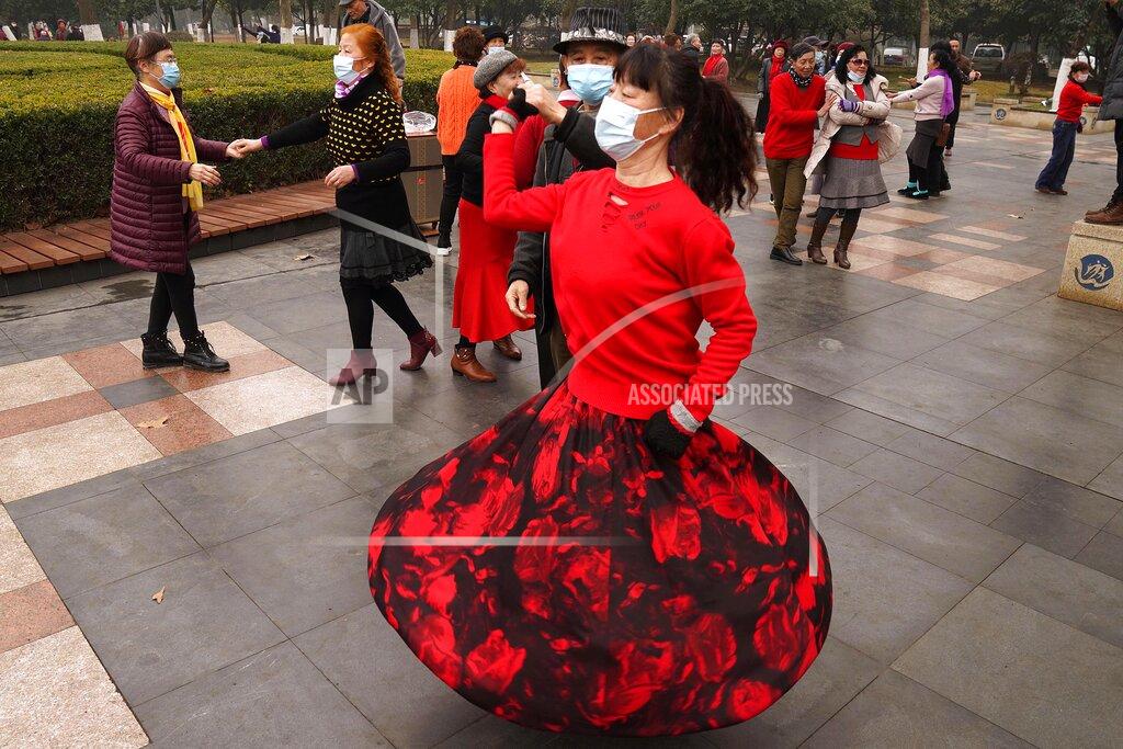 Ng Han Guan Residents wear masks as they dance at a park in Wuhan in central China's Hubei Province on Saturday, Jan. 23, 2021. A year after it was locked down to contain the spread of coronavirus, the central Chinese city of Wuhan has largely returned to normal, even as China continues to battle outbreaks elsewhere in the country. (AP Photo/Ng Han Guan)