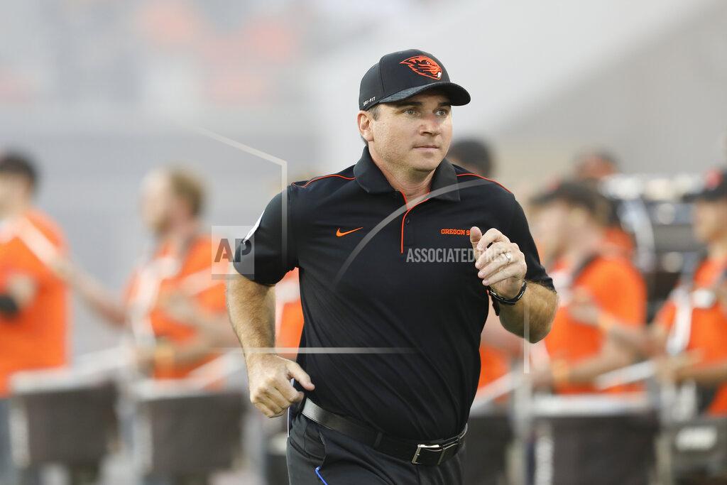 Oregon State coach Jonathan Smith runs onto the field for the team's NCAA college football game against Oklahoma State in Corvallis, Ore., Friday, Aug. 30, 2019. (AP Photo/Amanda Loman)
