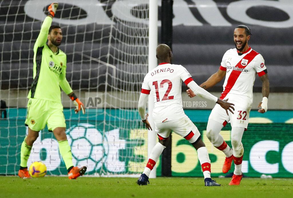 Andrew Boyers Southampton's Theo Walcott, right, celebrates with teammate Moussa Djenepo after scoring his team's first goal during the English Premier League soccer match between Wolverhampton Wanderers and Southampton at Molineux Stadium in Wolverhampton, England, Monday, Nov. 23, 2020. (Andrew Boyers, Pool via AP)
