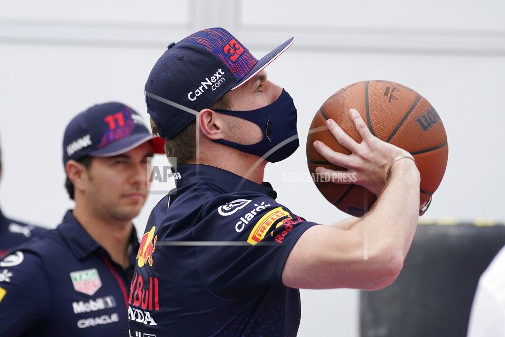 Darron Cummings Red Bull driver Max Verstappen, of the Netherlands, shoots a free throw as teammate Sergio Perez, of Mexico, watches at the Formula One U.S. Grand Prix auto race at Circuit of the Americas, Thursday, Oct. 21, 2021, in Austin, Texas. F1 Teams took part in a free throw challenge to help the NBA celebrate its 75th anniversary. (AP Photo/Darron Cummings)