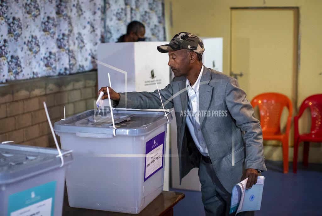 Ben Curtis An Ethiopian man casts his vote in the general election at a polling center in the capital Addis Ababa, Ethiopia Monday, June 21, 2021. Ethiopia was voting on Monday in the greatest electoral test yet for Prime Minister Abiy Ahmed as insecurity and logistical issues meant ballots wouldn't be cast in more than 100 constituencies of the 547 across the country. (AP Photo/Ben Curtis)