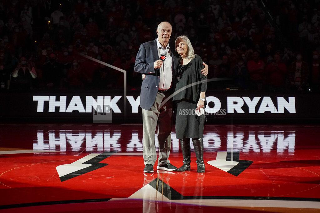 Andy Manis Bo Ryan, a former Wisconsin basketball coach, and his wife, Kelly Ryan, hug during a ceremony to celebrate Bo's 15 seasons as coach, at halftime of the team's NCAA college basketball game against Wisconsin-Green Bay on Friday, Nov. 12, 2021, in Madison, Wis. Ryan led Wisconsin to a school-record of 364 wins in 15 seasons. (AP Photo/Andy Manis)