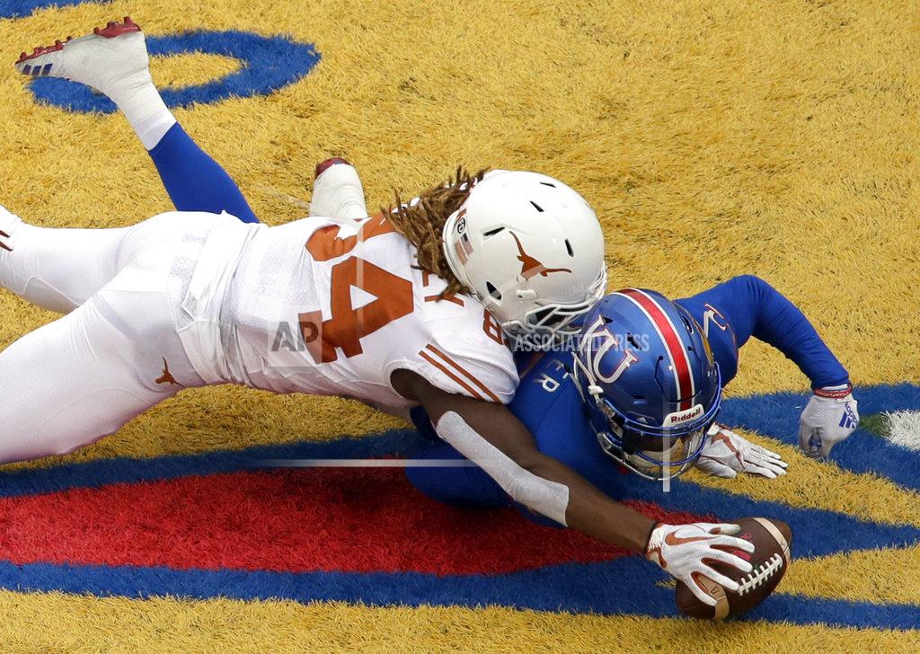 Orlin Wagner Kansas safety Tyrone Miller Jr. (22) recovers an on-sides kick ahead of Texas wide receiver Lil'Jordan Humphrey (84) during the second half of an NCAA college football game in Lawrence, Kan., Friday, Nov. 23, 2018. Texas defeated Kansas 24-17. (AP Photo/Orlin Wagner)