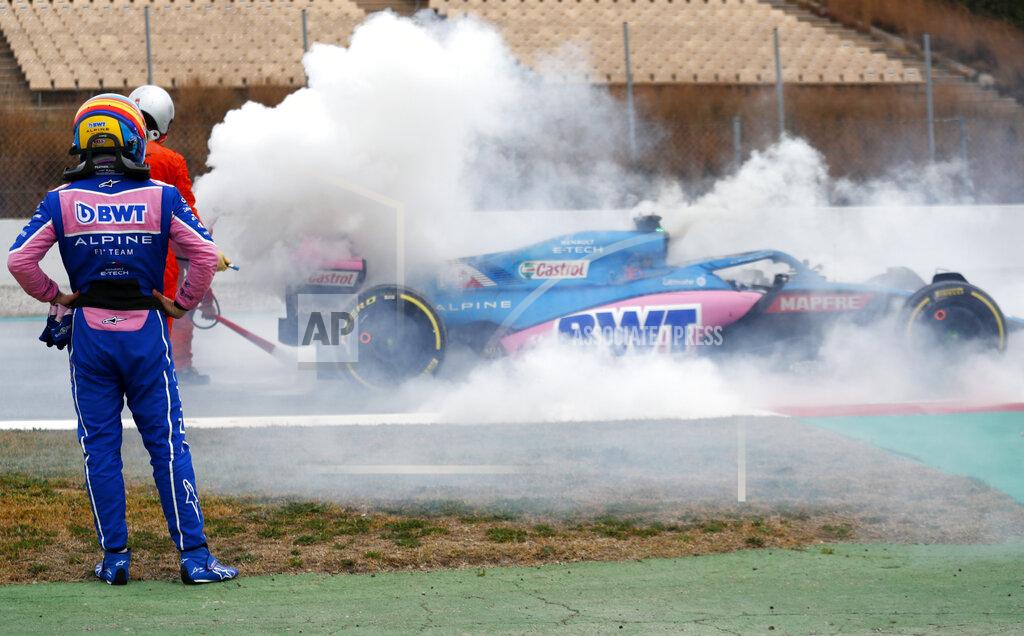 Joan Monfort Alpine driver Fernando Alonso of Spain watches smoke pour from his car during a Formula One pre-season testing session at the Catalunya racetrack in Montmelo, just outside of Barcelona, Spain, Friday, Feb. 25, 2022. (AP Photo/Joan Monfort)