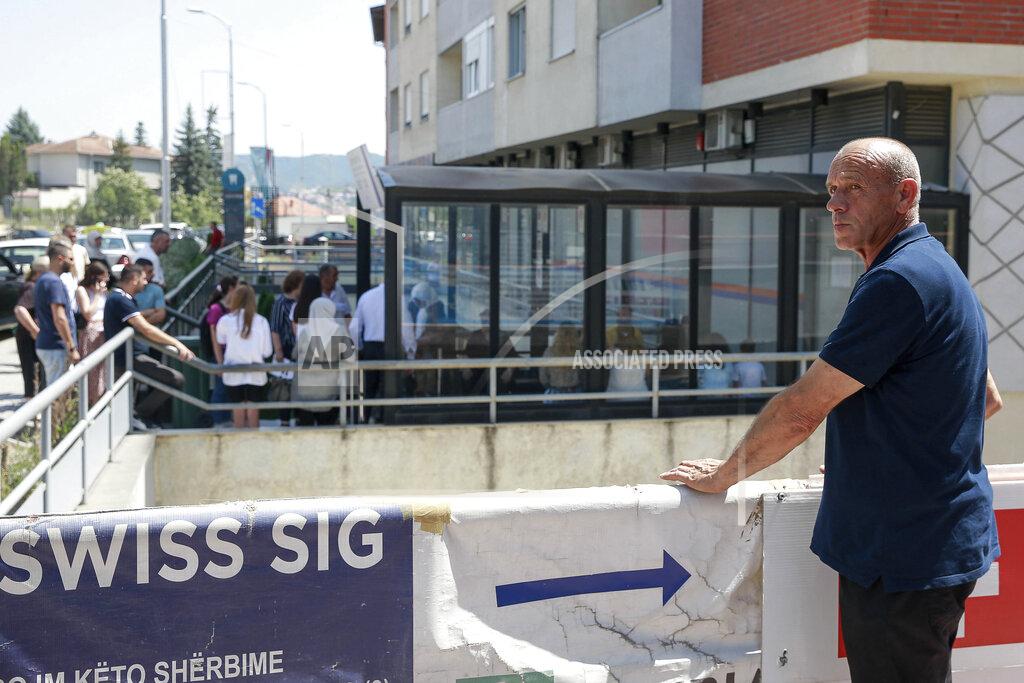Visar Kryeziu Kosovo citizen Faik Ibriqi, 60, waits for the second day outside of a Swiss office where Kosovars apply for the Schengen visa in Kosovo's capital Pristina, Tuesday, June 28, 2022. The European Union’s delay in allowing visa-free travel for the people of Kosovo has spread dismay and resentment in the continent’s newest state, and one Pristina businessman has retaliated by hitting EU officials where it hurts — the stomach. (AP Photo/Visar Kryeziu)
